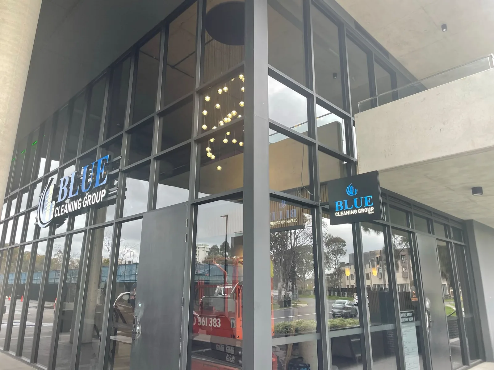 The Blue Cleaning Group illuminated sign in the window of our glazed corner shopfront